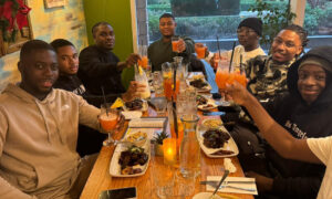 Group of colleagues and students eating at a restaurant