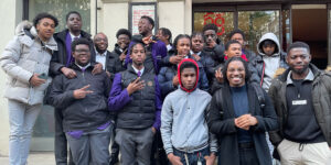 Group of pupils with BMT colleagues outside a venue.